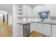 Modern kitchen with white cabinets, granite counters, and stainless steel dishwasher at 211 Colonial Homes Nw Dr # 1105, Atlanta, GA 30309