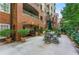 Brick building with a patio featuring a table and chairs at 211 Colonial Homes Nw Dr # 1105, Atlanta, GA 30309