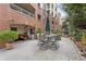 A charming patio area with an outdoor table and chairs, surrounded by potted plants at 211 Colonial Homes Nw Dr # 1105, Atlanta, GA 30309