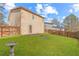 Backyard with a small patio, wood fence, and a lush green lawn at 6118 Dorsett St, Douglasville, GA 30134