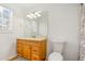 Bright bathroom with a wood vanity, light countertops, and ample lighting at 6118 Dorsett St, Douglasville, GA 30134