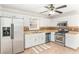 Well-lit kitchen featuring white cabinets and stainless steel appliances at 6118 Dorsett St, Douglasville, GA 30134