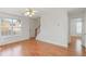 Bright living room with hardwood floors, ceiling fan, and sun-filled window at 6118 Dorsett St, Douglasville, GA 30134