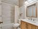 Modern bathroom with white subway tile and wood vanity at 6229 Grand Loop Rd, Sugar Hill, GA 30518