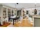 Kitchen dining area with a farmhouse table and natural light from large windows at 6229 Grand Loop Rd, Sugar Hill, GA 30518