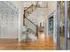 Two-story entryway with hardwood floors, a grand staircase, and decorative wallpaper at 6229 Grand Loop Rd, Sugar Hill, GA 30518