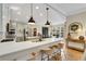 Modern kitchen with white quartz counters, light green cabinets, and stainless steel appliances at 6229 Grand Loop Rd, Sugar Hill, GA 30518