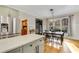 Kitchen features white and green cabinets, quartz countertops, and a large island at 6229 Grand Loop Rd, Sugar Hill, GA 30518