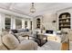 Bright living room with stone fireplace and built-in shelves at 6229 Grand Loop Rd, Sugar Hill, GA 30518