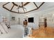 Bright main bedroom with hardwood floors, a tray ceiling, and access to a private balcony at 6229 Grand Loop Rd, Sugar Hill, GA 30518