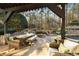 Outdoor patio with fire pit, seating area, and dining table at 6229 Grand Loop Rd, Sugar Hill, GA 30518