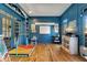 Playroom with blue walls, hardwood floors, and built-in bookcases at 6229 Grand Loop Rd, Sugar Hill, GA 30518