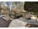 Expansive backyard oasis with a stone patio and fire pit at 6229 Grand Loop Rd, Sugar Hill, GA 30518