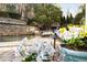 Picturesque poolside view with colorful flowers and stone accents at 6229 Grand Loop Rd, Sugar Hill, GA 30518