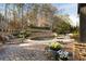 Landscaped backyard with a large, inviting pool and stone retaining walls at 6229 Grand Loop Rd, Sugar Hill, GA 30518