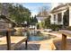 Relaxing pool area with wooden lounge chairs and a stone patio at 6229 Grand Loop Rd, Sugar Hill, GA 30518