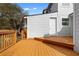 Spacious back deck of home with white siding, wooden railing, and stairs up to back door at 8168 Canyon Forge Dr, Riverdale, GA 30274