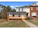 Charming townhouse with painted brick and a cozy front porch, perfect for relaxing outdoors at 8168 Canyon Forge Dr, Riverdale, GA 30274