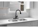 A kitchen counter features new quartz countertops, a stainless-steel sink, and new fixtures at 8168 Canyon Forge Dr, Riverdale, GA 30274