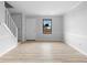 The bright living room features freshly painted walls, wood floors, and a modern staircase at 8168 Canyon Forge Dr, Riverdale, GA 30274