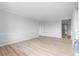 Bright living room with light wood flooring, fresh paint, and modern trim throughout at 8168 Canyon Forge Dr, Riverdale, GA 30274