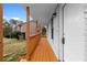 Covered porch with wooden floors and railings offers a charming entry to this freshly updated home at 8168 Canyon Forge Dr, Riverdale, GA 30274
