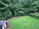 Large, grassy backyard with mature trees and shed at 232 Taylors Farm Dr, Canton, GA 30115