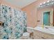 Cozy bathroom featuring a shower with blue floral curtain and classic vanity at 232 Taylors Farm Dr, Canton, GA 30115