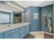 A charming bathroom featuring double sinks, a large mirror, and stylish blue cabinetry at 232 Taylors Farm Dr, Canton, GA 30115
