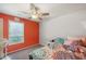 Cozy bedroom offers a colorful accent wall, ceiling fan and window providing natural light at 232 Taylors Farm Dr, Canton, GA 30115