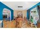 Dining room with hardwood floors, bright blue accent wall and view to fireplace and living spaces at 232 Taylors Farm Dr, Canton, GA 30115
