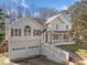 The front exterior of the home featuring a two-car garage and covered porch at 232 Taylors Farm Dr, Canton, GA 30115
