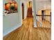Open hallway featuring hardwood floors and arched entryway into the kitchen and stairs at 232 Taylors Farm Dr, Canton, GA 30115