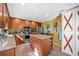 A bright kitchen featuring wood cabinets, an island with granite countertops, and stainless steel appliances at 232 Taylors Farm Dr, Canton, GA 30115