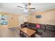 Open living room showcasing gray flooring, fireplace, comfortable seating, and natural lighting at 232 Taylors Farm Dr, Canton, GA 30115