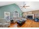 The living room with vaulted ceilings, hardwood floors, and a fireplace at 232 Taylors Farm Dr, Canton, GA 30115