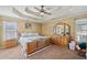 A serene primary bedroom featuring a tray ceiling, ceiling fan, and neutral decor at 232 Taylors Farm Dr, Canton, GA 30115