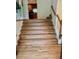 Elegant staircase with hardwood steps and white railing leading to the upper level at 232 Taylors Farm Dr, Canton, GA 30115