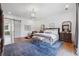 Spacious bedroom with hardwood floors and sliding barn door at 3842 Ernest W Barrett Sw Pkwy, Marietta, GA 30064