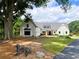 White farmhouse exterior with large windows, attached garage, and landscaping at 3842 Ernest W Barrett Sw Pkwy, Marietta, GA 30064