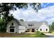 Charming white farmhouse with a three-car garage and beautiful landscaping at 3842 Ernest W Barrett Sw Pkwy, Marietta, GA 30064