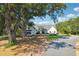 Modern farmhouse exterior with large tree and driveway at 3842 Ernest W Barrett Sw Pkwy, Marietta, GA 30064