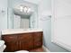 Charming bathroom with light blue walls, wood vanity and updated fixtures at 4698 Norman Nw Dr, Kennesaw, GA 30144