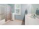 Bathroom with vanity, shower/tub combo, and linen cabinet at 4698 Norman Nw Dr, Kennesaw, GA 30144