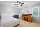 Bright bedroom with a queen bed, desk, and window at 4698 Norman Nw Dr, Kennesaw, GA 30144