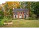 Two-story brick house with a large front yard and mature trees at 4698 Norman Nw Dr, Kennesaw, GA 30144