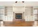 Brick fireplace with built-in shelving and hardwood floors at 4698 Norman Nw Dr, Kennesaw, GA 30144