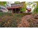 Back exterior showcasing a multi-level deck and wooded landscape at 4698 Norman Nw Dr, Kennesaw, GA 30144