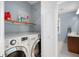 Convenient laundry room with washer, dryer, and shelves at 4698 Norman Nw Dr, Kennesaw, GA 30144