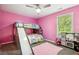 Pink bedroom with bunk beds and a play kitchen at 93 Carriage Lake Dr, Stockbridge, GA 30281